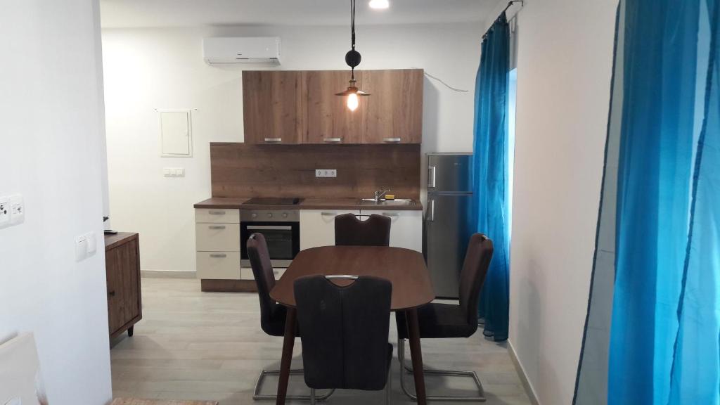 a kitchen with a table and chairs in a room at Stars Palace Vodice in Vodice