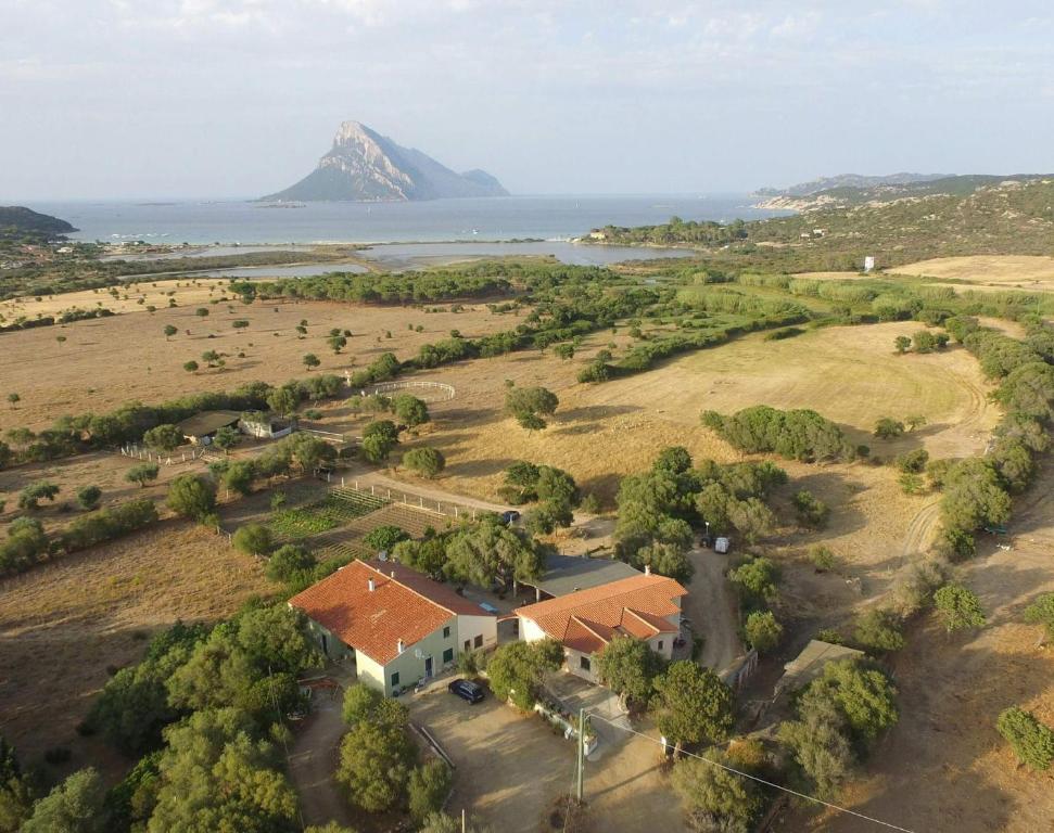 an aerial view of a house with a mountain in the background at B&B La Taerra in Porto San Paolo