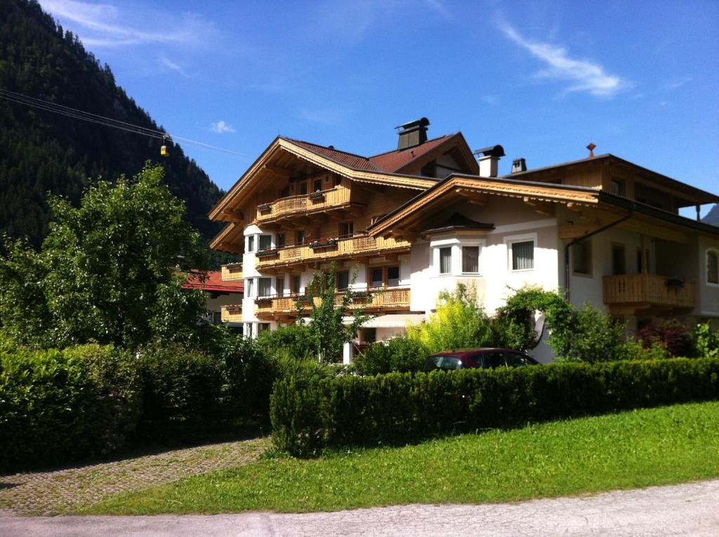 a building with a car parked in front of it at Apart Austria in Mayrhofen