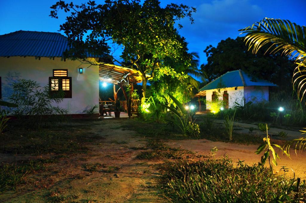 a night view of a house with lights at Sea sound cabana & Restaurant in Tangalle