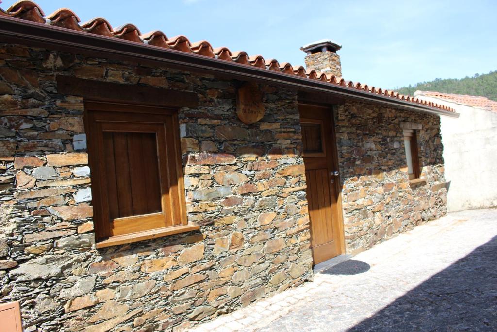 um edifcio de pedra com uma porta de madeira em Casa da Comareira em Gis