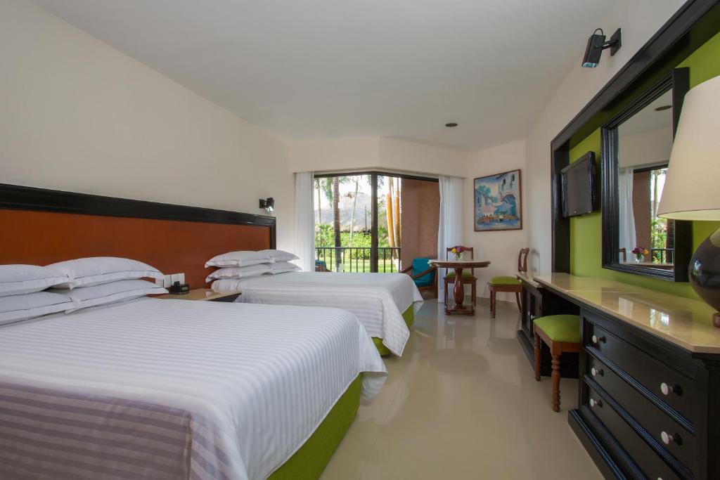 Postel nebo postele na pokoji v ubytování Barceló Huatulco - All Inclusive