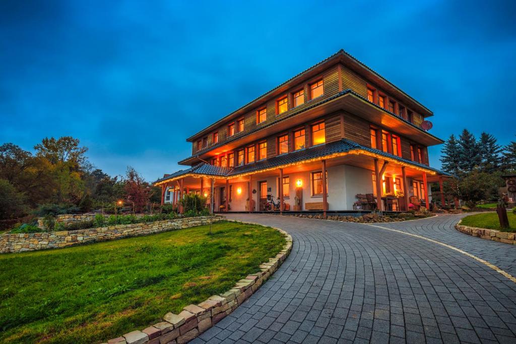 a large house on a cobblestone road at Qi Gong Haus in Roßdorf