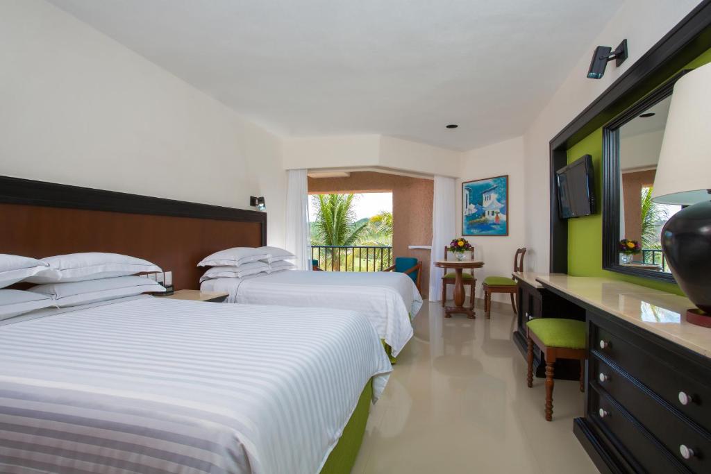 Postel nebo postele na pokoji v ubytování Barceló Huatulco - All Inclusive