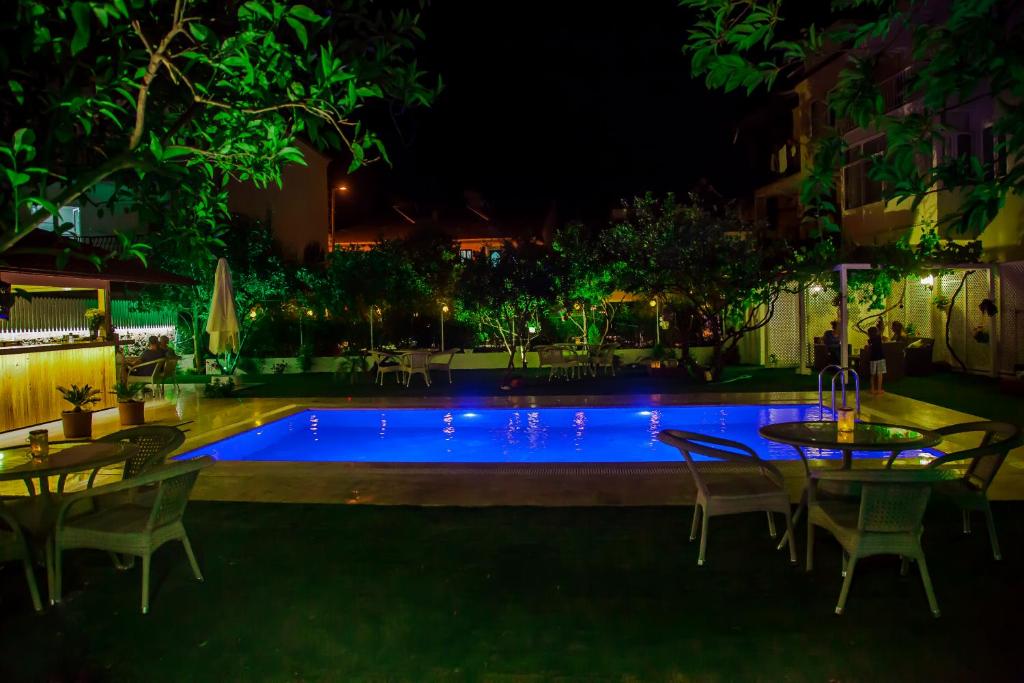 a swimming pool at night with tables and chairs at Grandma's Garden in Dalyan