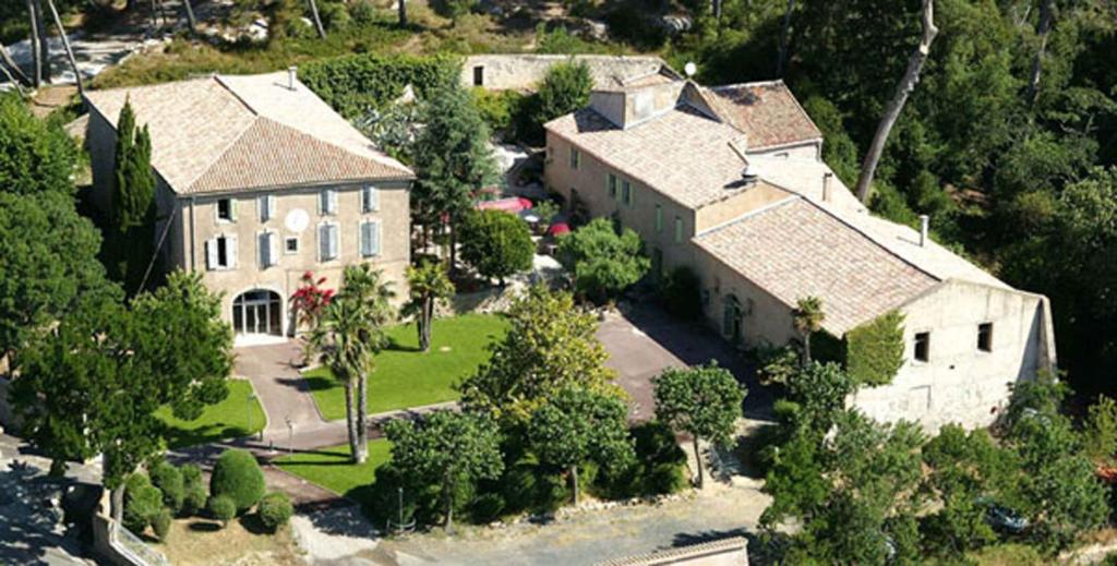 an aerial view of a large house with a yard at domaine de bessilles in Montagnac