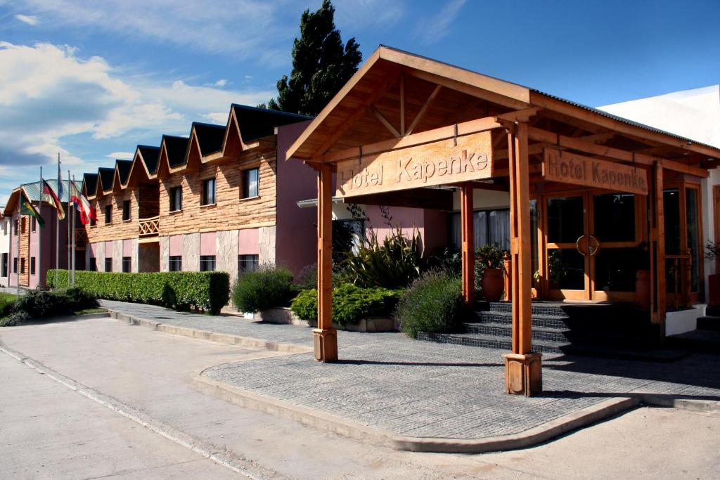 a building with a pavilion in front of it at Hotel Kapenke in El Calafate