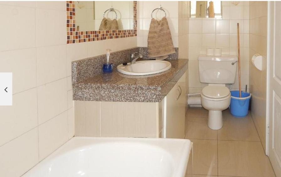 a bathroom with a sink and a toilet at Durban Seashore in Durban