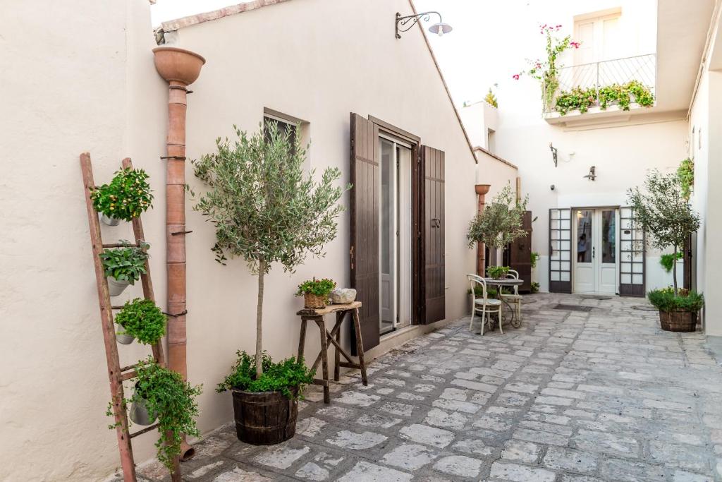 a courtyard with potted plants on the side of a building at Borgo San Gaetano in Bernalda