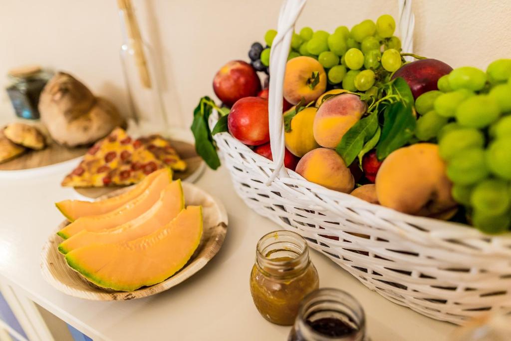 a table with a basket of fruit on it at Borgo San Gaetano in Bernalda