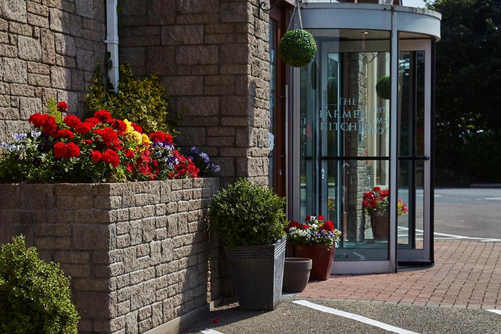 a store with flowers in front of a building at The Farmers Kitchen Hotel in Wexford