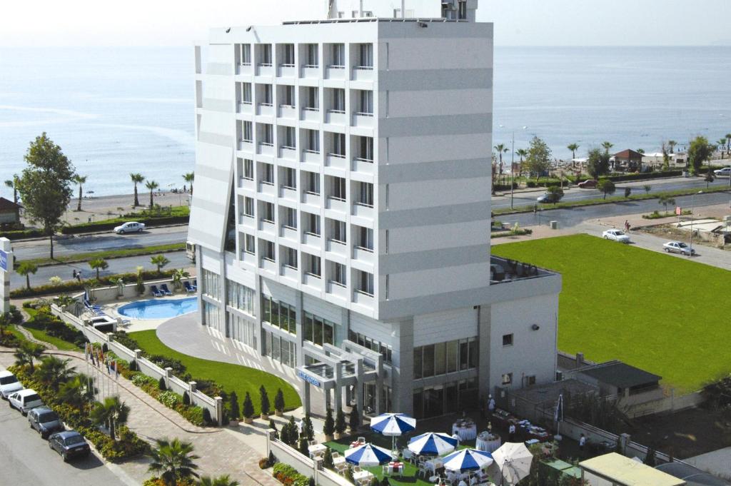 an aerial view of a hotel with the ocean in the background at Blue Garden Hotel in Antalya