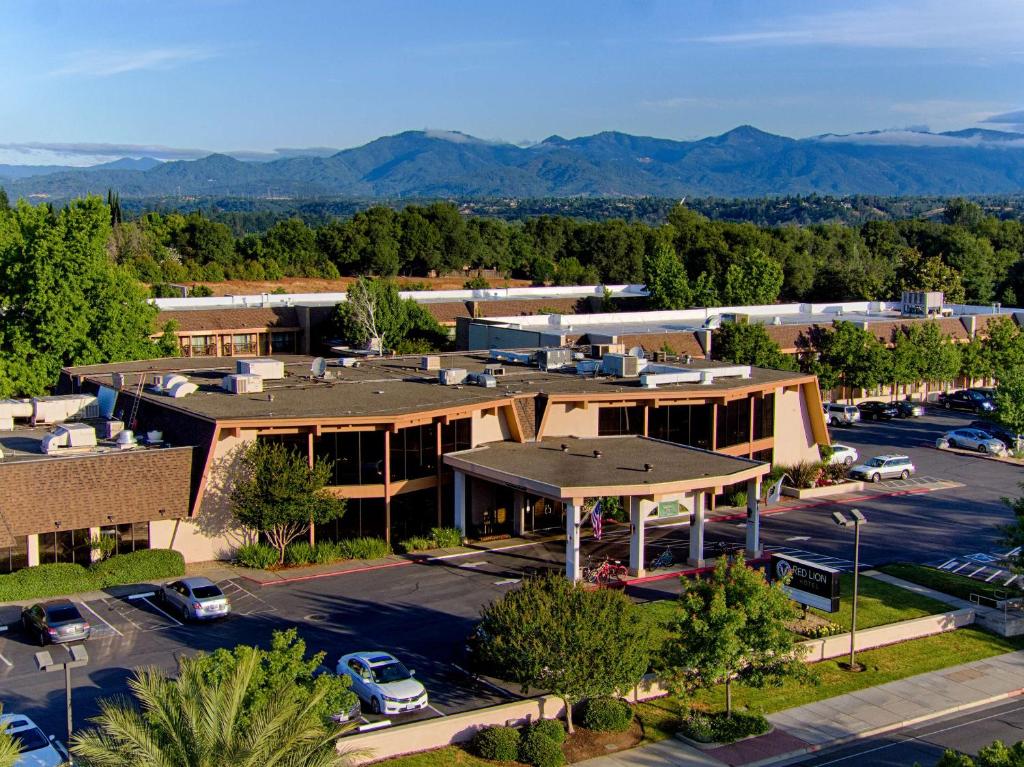 an aerial view of a building with a parking lot at Red Lion Hotel Redding in Redding