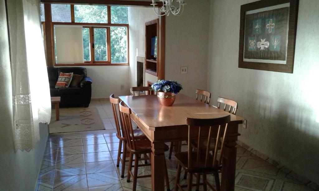 a dining room with a wooden table and chairs at Casa de La Luna in Monte Verde