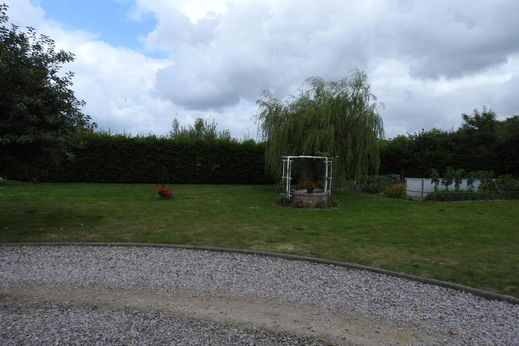 a yard with a gazebo in the grass at Chambres d'Hotes Elvire et Laurent Barbey in Sainte-Marie-du-Mont