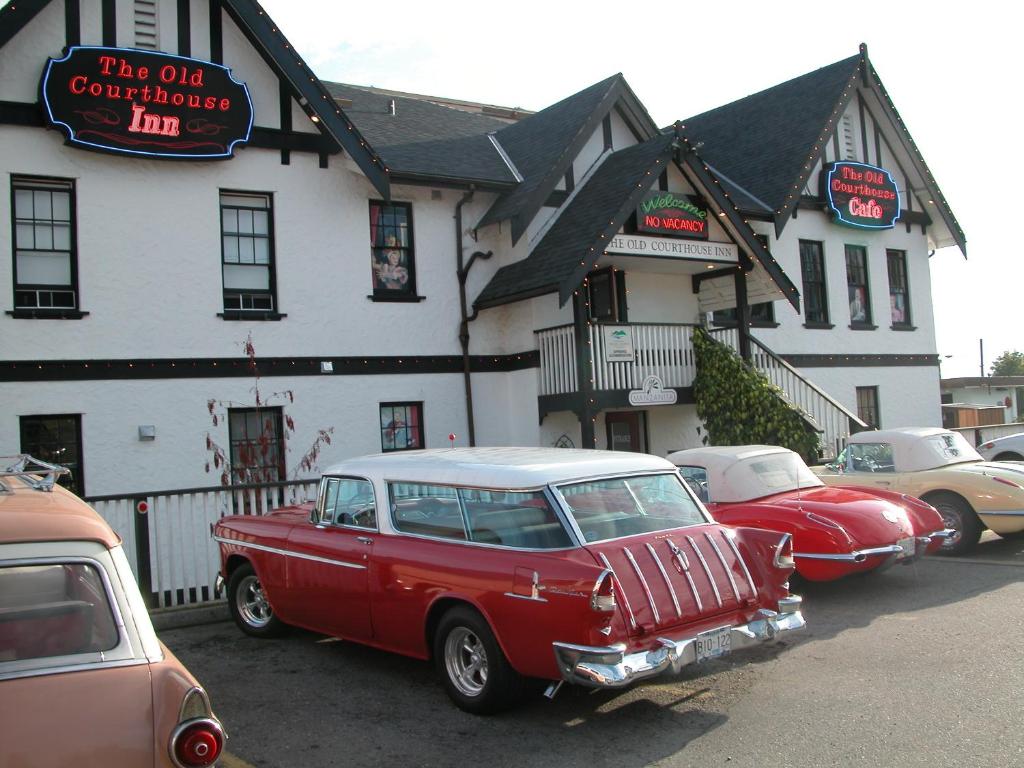 a group of cars parked in front of a building at The Old Courthouse Inn in Powell River