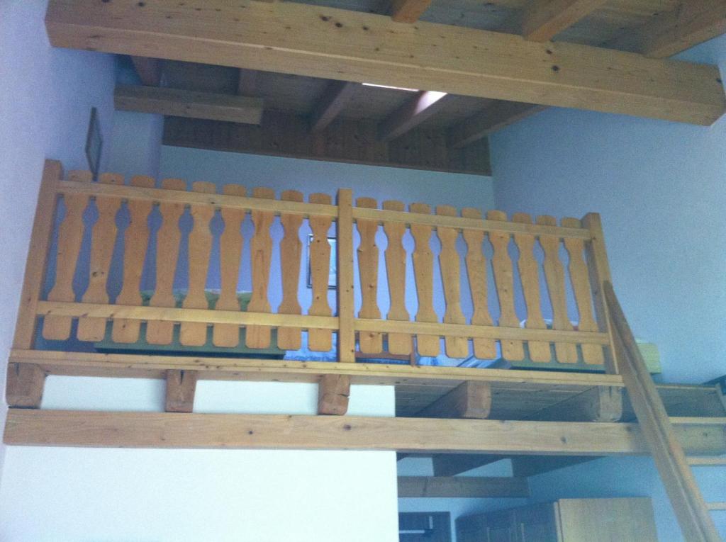 a wooden bench sitting on top of a ceiling at Hotel Pizzeria Selva in Zernez