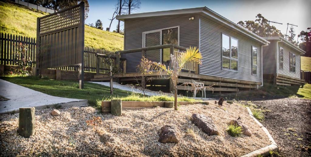 a small house with a garden in front of it at Sunny Gum in Penguin