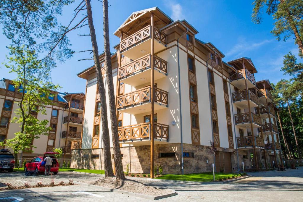 a large building with wooden balconies on it at Rezydencja Park Rodzinna - FAF in Mielno