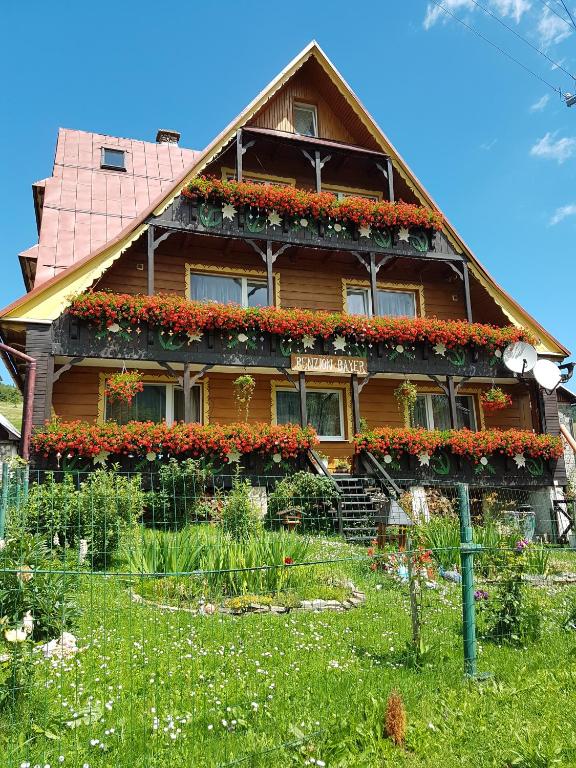 a house with flowers on the side of it at Privát Bayer in Ždiar