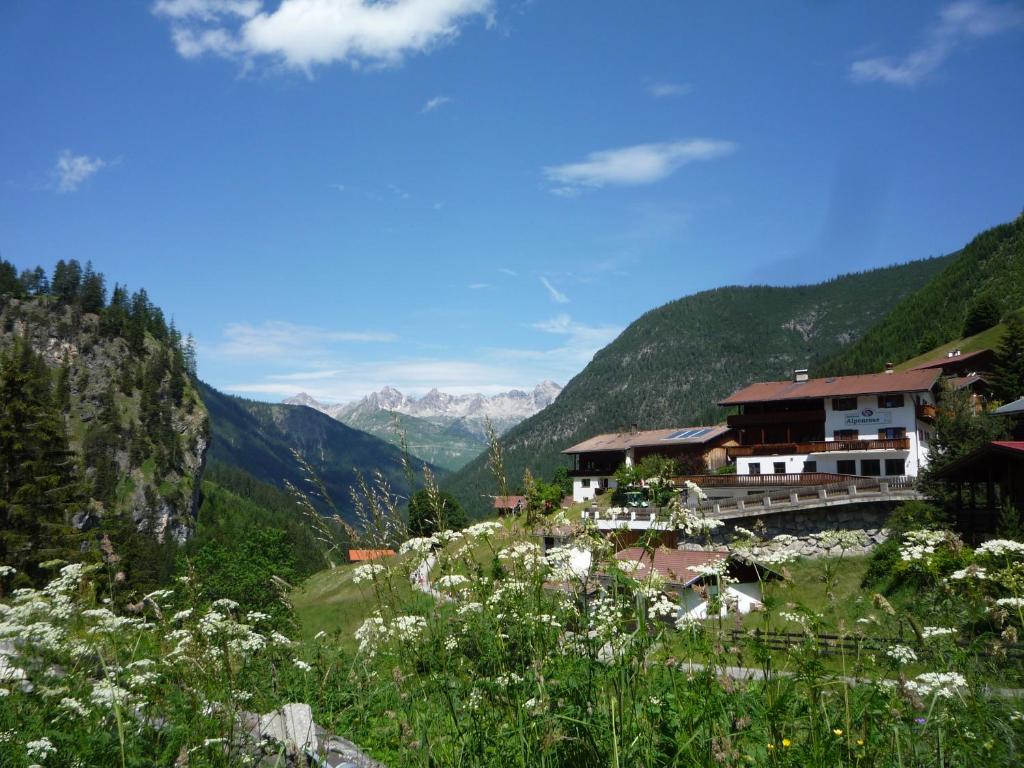 a village in a valley with mountains in the background at Gasthaus Alpenrose in Gramais