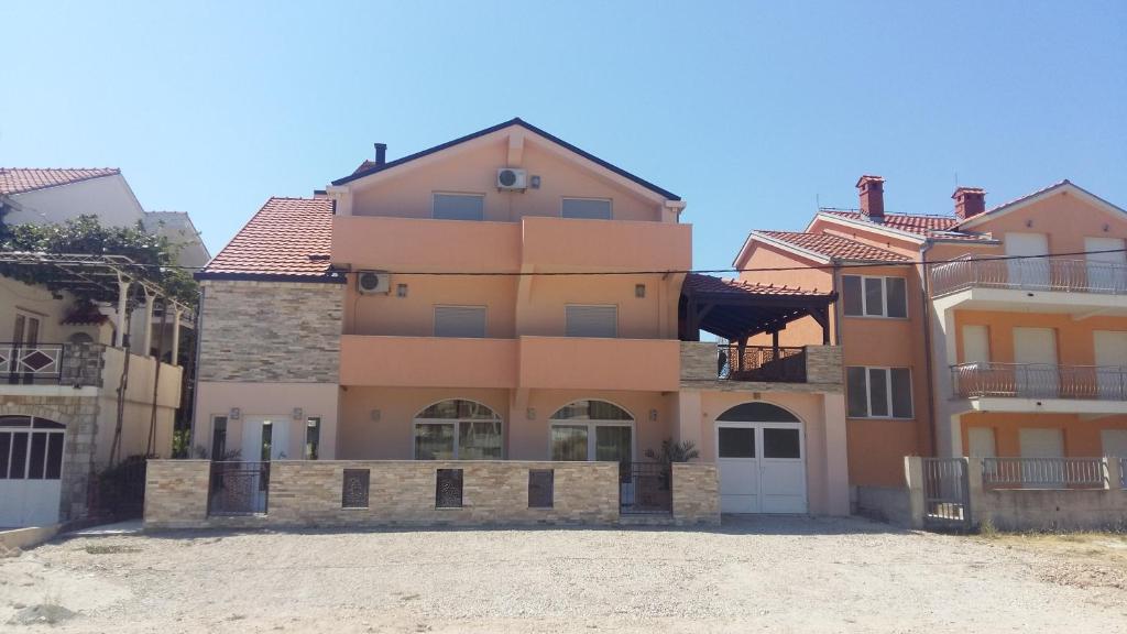 a large house with a driveway in front of it at Apartments Ema in Ivanica