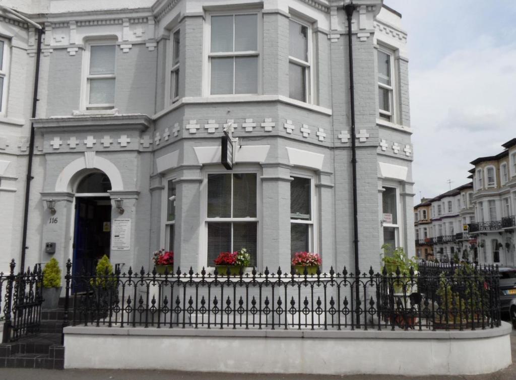 a house with a fence in front of it at Seamore Guest House in Great Yarmouth