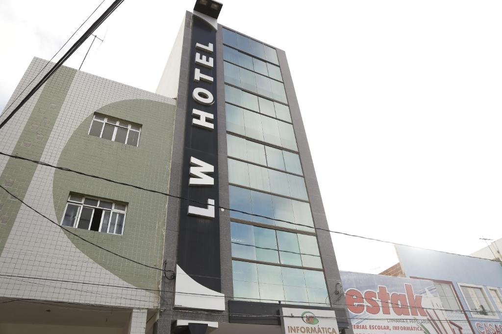 a building with a sign on the side of it at LW Hotel in Arcoverde