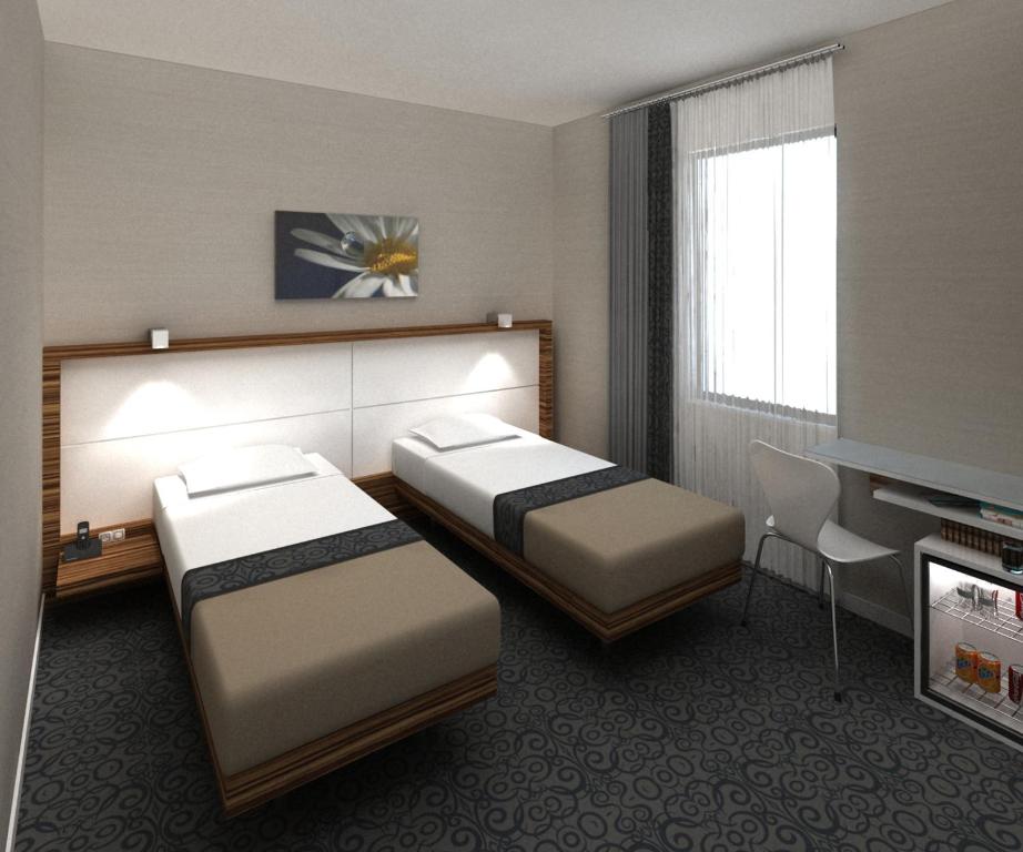 En eller flere senge i et værelse på Hotel Yenibosna