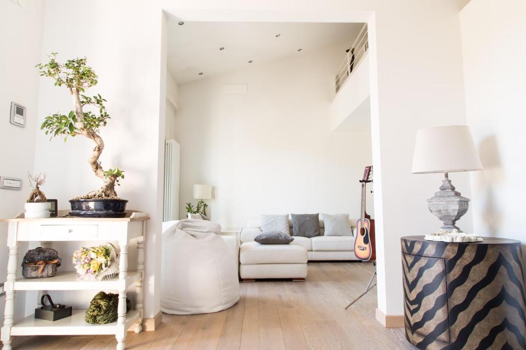 a living room with a couch and a guitar at La Rosa dei Sensi Luxury Villa Apt 1 in Montecarlo