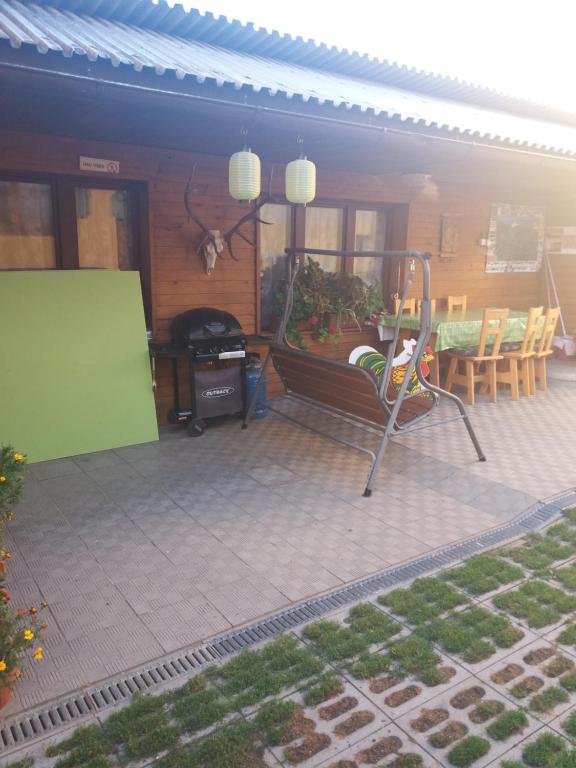 a patio of a house with a table and chairs at Chata u Jozefa in Hrabušice