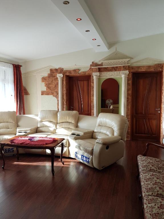 a living room with a couch and a coffee table at Atgiris in Palanga
