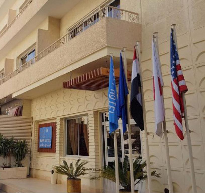 a group of flags in front of a building at Hapi Hotel in Aswan