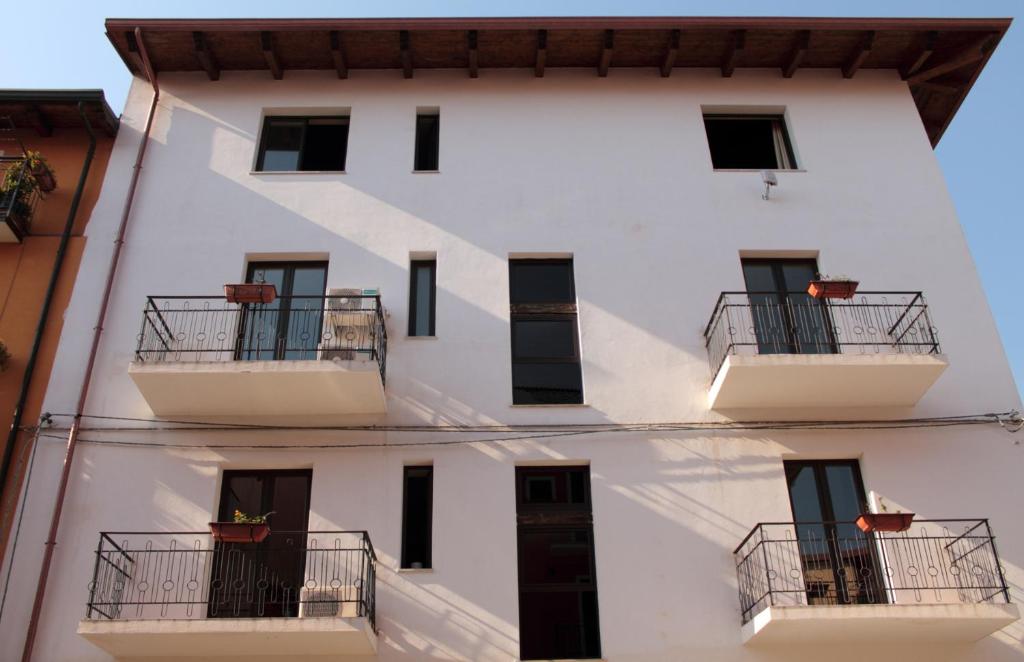 ラメーツィア・テルメにあるB&B Pinarinaのバルコニーと窓が備わる白い建物です。