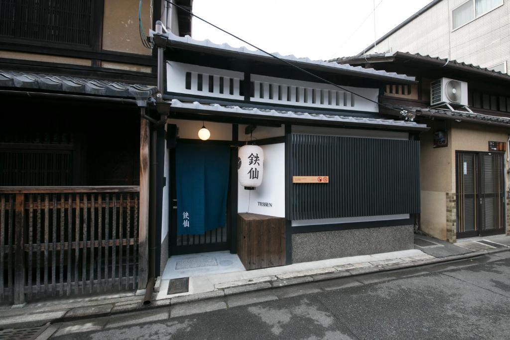 a building with a blue door on a street at さと居 鉄仙 SATOI TESSEN Omiya-Gojo in Kyoto