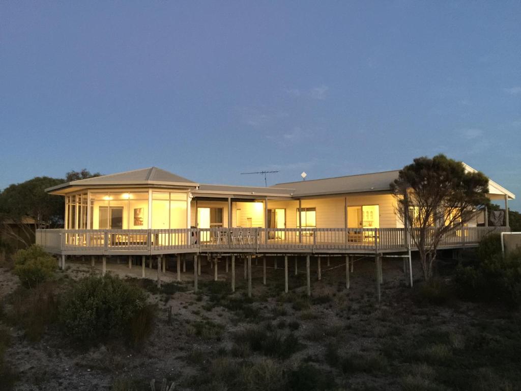 a house on a dock with the lights on at White Sands Holiday Retreat in Island Beach