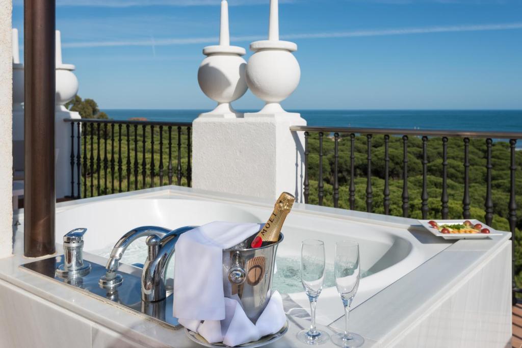 a sink with glasses and a bottle of champagne at TUI Blue Isla Cristina Palace - Adults Recommended in Isla Cristina