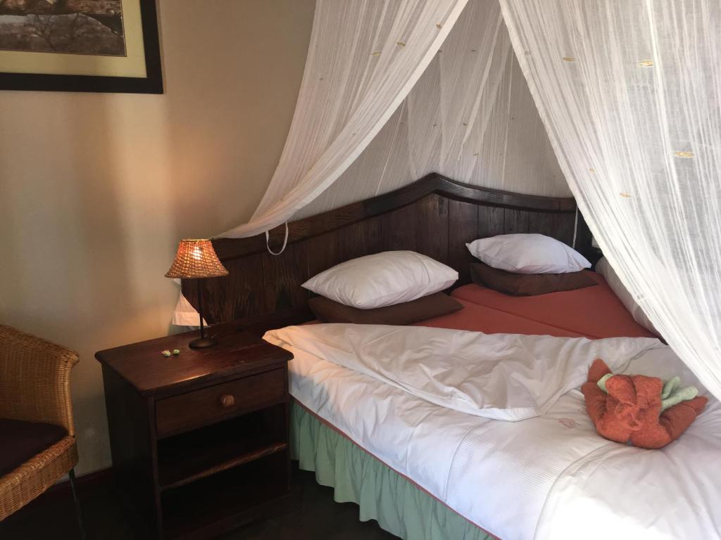 a bedroom with a bed with a teddy bear on it at Düsternbrook Guest Farm in Dusternbrook