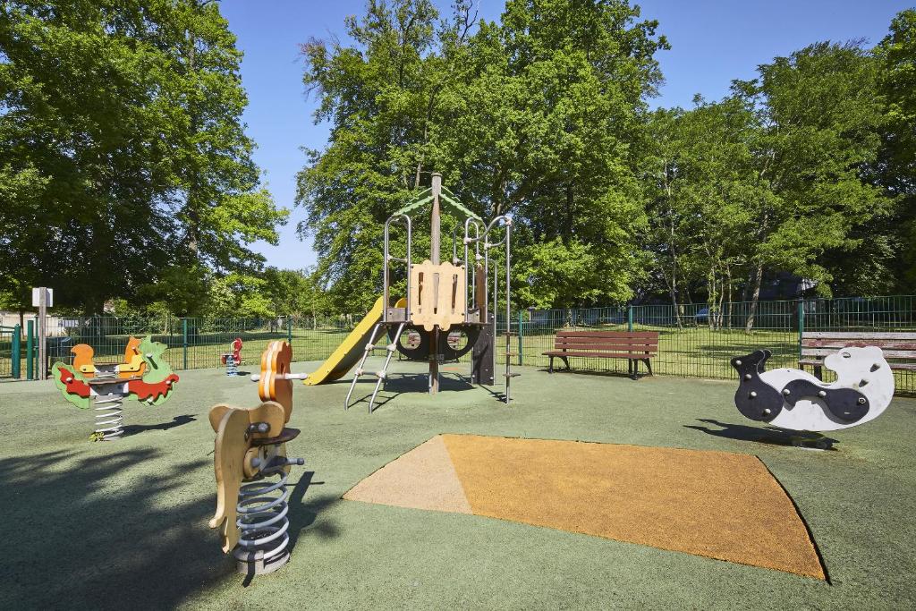 a playground with a slide and a swing at Campanile Hotel Compiegne in Compiègne