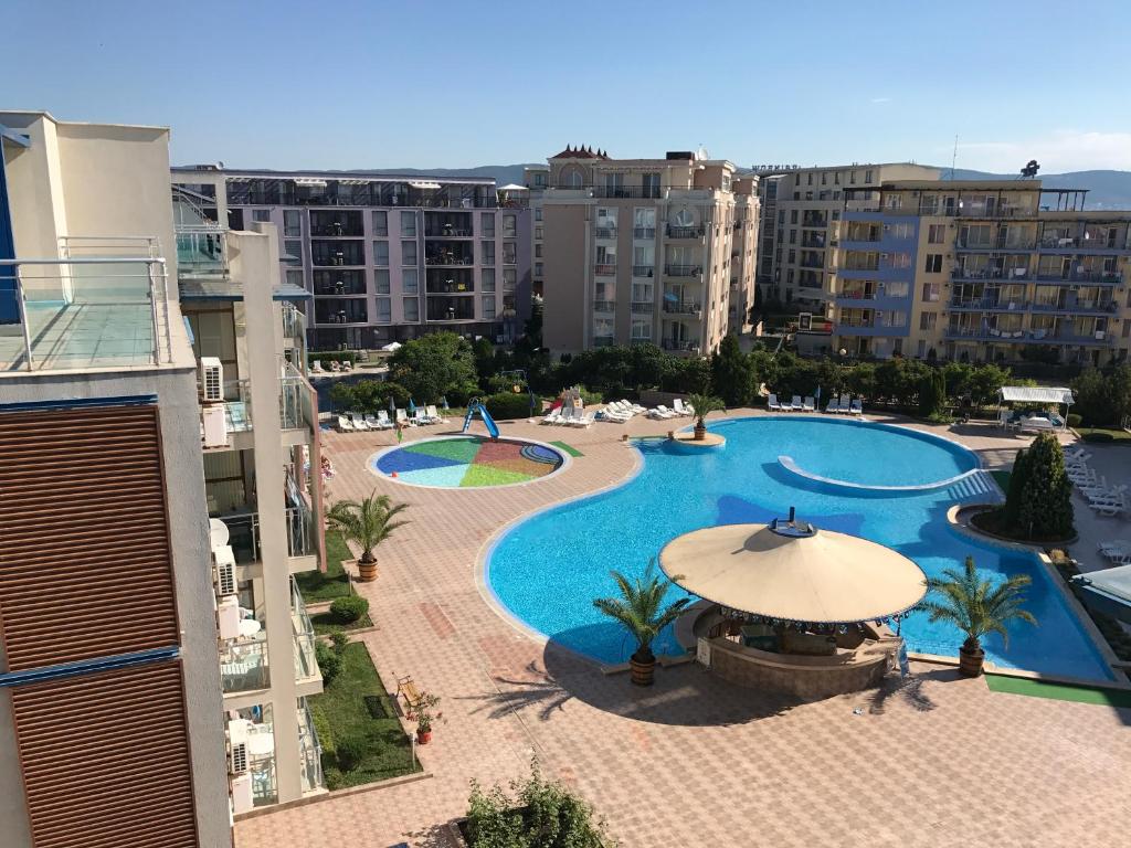 an overhead view of a swimming pool with an umbrella at Sun City 1 - Family Apart Complex in Sunny Beach