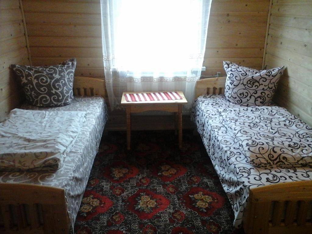 Postel nebo postele na pokoji v ubytování Romashka Guest House