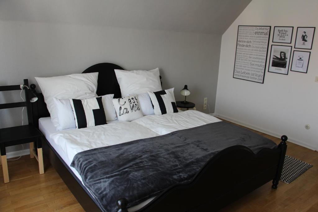 a bedroom with a bed with black and white pillows at Stadtvilla Hameln in Hameln