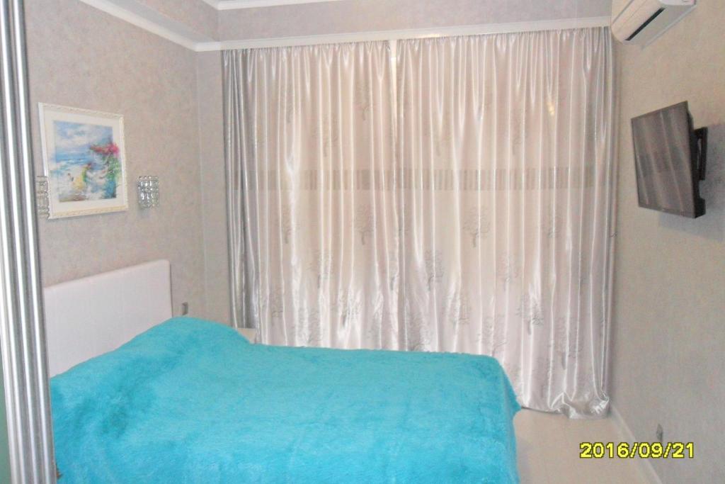 
Кровать или кровати в номере Апартаменты на Черноморской
