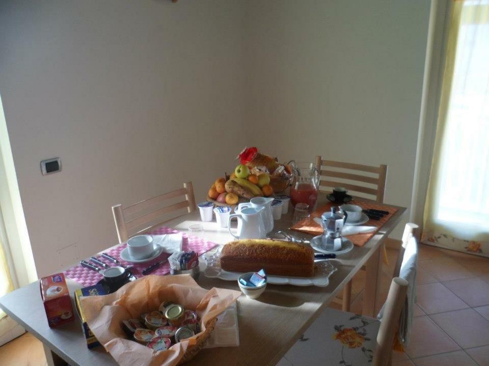 a dining room table with a table with food on it at B&B Villa I Nobili in Cava deʼ Tirreni
