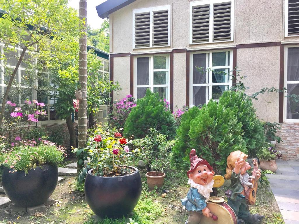 a garden with plants in front of a house at Champs Yazuh B&amp;B in Jiji