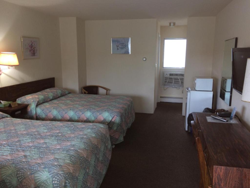 Postel nebo postele na pokoji v ubytování Crystal Sands Motel