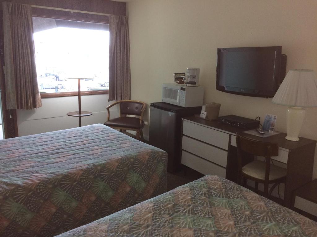 Postel nebo postele na pokoji v ubytování Crystal Sands Motel