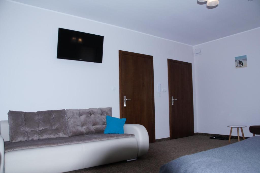 Televízia a/alebo spoločenská miestnosť v ubytovaní Apartamenty Patria