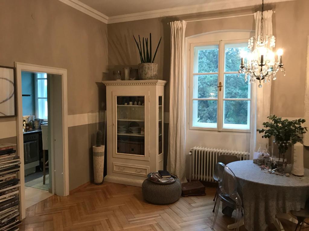 a dining room with a table and a chandelier at Apartment Lakeside in Salzburg
