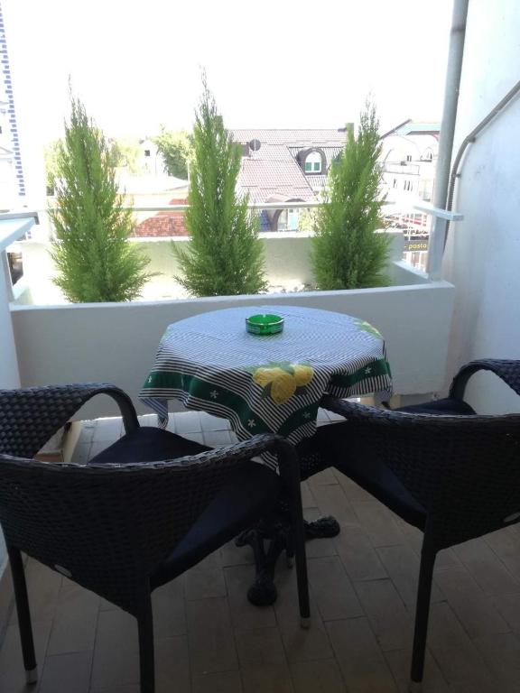 a table and two chairs on a balcony at Apartment Pluvia in Osijek